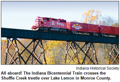 All aboard! The Indiana Bicentennial Train crosses the Shuffle Creek trestle over Lake Lemon in Monroe County. Image courtesy Indiana Historical Society.