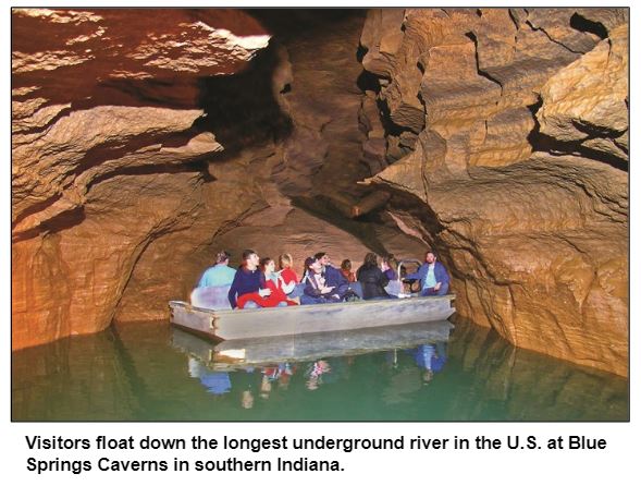 Visitors float down the longest underground river in the U.S. at Blue Springs Caverns in southern Indiana.