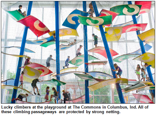 Children climb high in the air, with protective netting, at The Commons playground in Columbus, Ind.