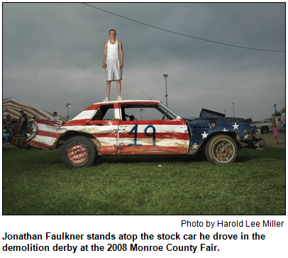 Jonathan Faulkner stands atop the stock car he drove in the demolition derby at the 2008 Monroe County Fair. Photo by Harold Lee Miller.