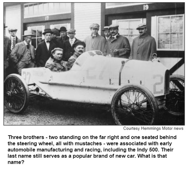 Three brothers - two standing on the far right and one seated behind the steering wheel, all with mustaches - were associated with early automobile manufacturing and racing, including the Indy 500. Their last name still serves as a popular brand of new car. What is that name?