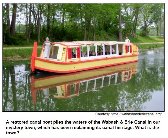A restored canal boat plies the waters of the Wabash & Erie Canal in our mystery town, which has been reclaiming its canal heritage. What is the town?