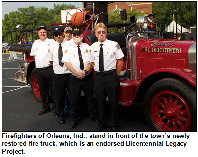 Firefighters of Orleans, Ind., stand in front of the town’s newly restored fire truck, which is an endorsed Bicentennial Legacy Project.