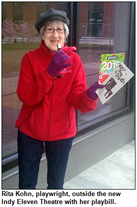 Rita Kohn, playwright, outside the new Indy Eleven Theatre with her playbill.