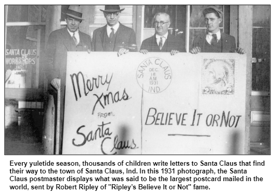 Every yuletide season, thousands of children write letters to Santa Claus that find their way to the town of Santa Claus, Ind. In this 1931 photograph, the Santa Claus postmaster displays what was said to be the largest postcard mailed in the world, sent by Robert Ripley of "Ripley’s Believe It or Not" fame.