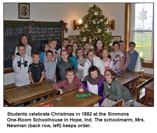 Students celebrate Christmas in 1892 at the Simmons One-Room Schoolhouse in Hope, Ind. The schoolmarm, Mrs. Newman (back row, left) keeps order.