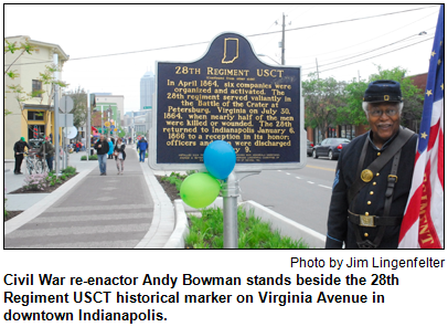 Civil War re-enactor Andy Bowman stands beside the 28th Regiment USCT historical marker on Virginia Avenue in downtown Indianapolis. Photo by Jim Lingenfelter.
