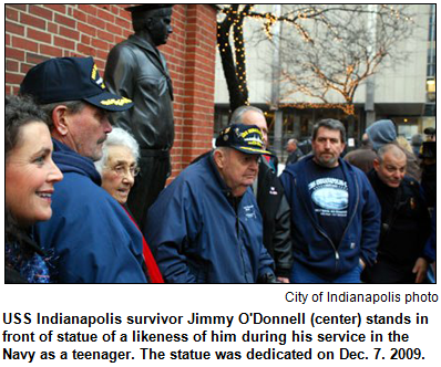 USS Indianapolis survivor Jimmy O'Donnell (center) stands in front of statue of a likeness of him during his service in the Navy as a teenager. The statue was dedicated on Dec. 7. 2009. City of Indianapolis photo.
