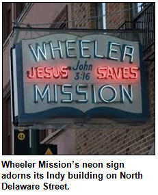Wheeler Mission’s neon sign adorns its Indy building on North Delaware Street.