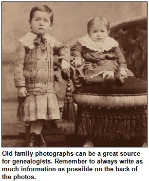 Vintage photograph of a boy and a girl in formal clothing. Old family photographs can be a great source for genealogists. Remember to always write as much information as possible on the back of the photos.