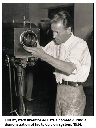 Our mystery inventor adjusts a camera during a demonstration of his television system, 1934.

