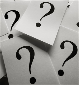 Image shows question marks printed on sheets of paper.