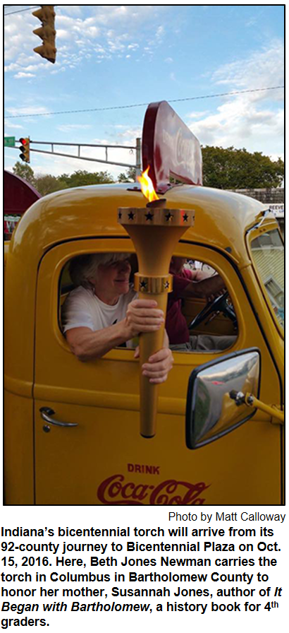 Indiana’s bicentennial torch will arrive from its 92-county journey to Bicentennial Plaza on Oct. 15, 2016. Here, Beth Jones Newman carries the torch in Columbus in Bartholomew County to honor her mother, Susannah Jones, author of It Began with Bartholomew, a history book for 4th graders.
 Photo by Matt Calloway.