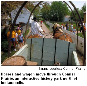 Horses and wagon move through Conner Prairie, an interactive history park north of Indianapolis. Image courtesy of Conner Prairie.