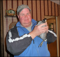 Don Gorney holds an American Coot, a surviving building-strike bird.