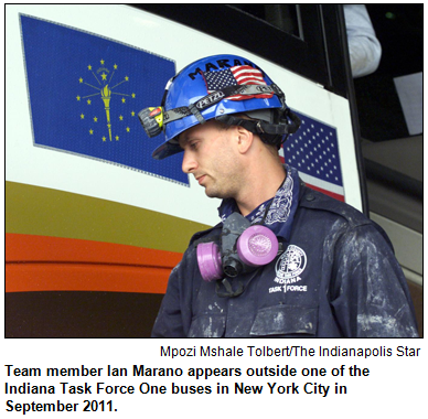 Team member Ian Marano appears outside one of the Indiana Task Force One buses in New York City in September 2011. 