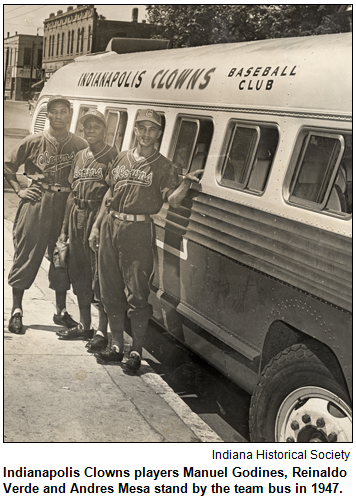 Indianapolis Clowns players Manuel Godines, Reinaldo Verde and Andres Mesa stand by the team bus in 1947. Image courtesy Indiana Historical Society.