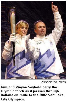 Kim and Wayne Seybold carry the Olympic torch as it passes through Indiana en route to the 2002 Salt Lake City Olympics.