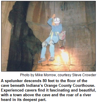 A spelunker descends 80 feet to the floor of the cave beneath Indiana’s Orange County Courthouse. Experienced cavers find it fascinating and beautiful, with a town above the cave and the roar of a river heard in its deepest part. Photo by Mike Morrow, courtesy Steve Crowder.