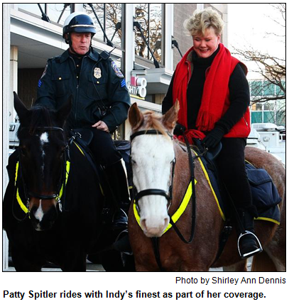 Patty Spitler rides horses with Indianapolis police mounted officer. Photo by Shirley Ann Dennis.