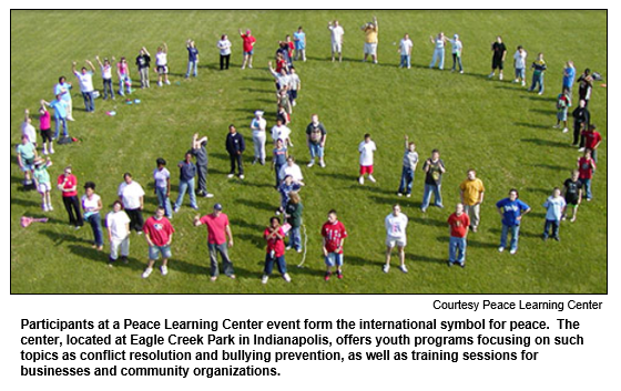 Participants at a Peace Learning Center event form the international symbol for peace.  The center, located at Eagle Creek Park in Indianapolis, offers youth programs focusing on such topics as conflict resolution and bullying prevention, as well as training sessions for businesses and community organizations.
Courtesy Peace Learning Center.