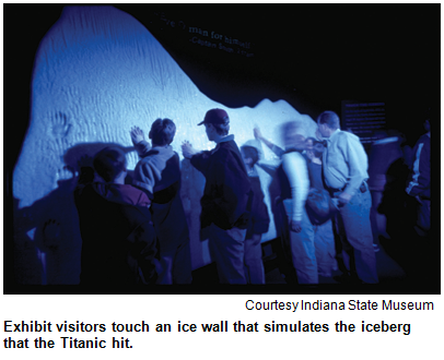 Exhibit visitors touch an ice wall that simulates the iceberg that the Titanic hit. Image courtesy Indiana State Museum.