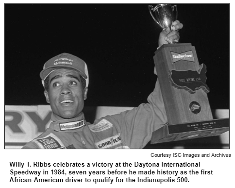 Willy T. Ribbs celebrates a victory at the Daytona International Speedway in 1984, seven years before he made history as the first African-American driver to qualify for the Indianapolis 500. Courtesy ISC Images and Archives.